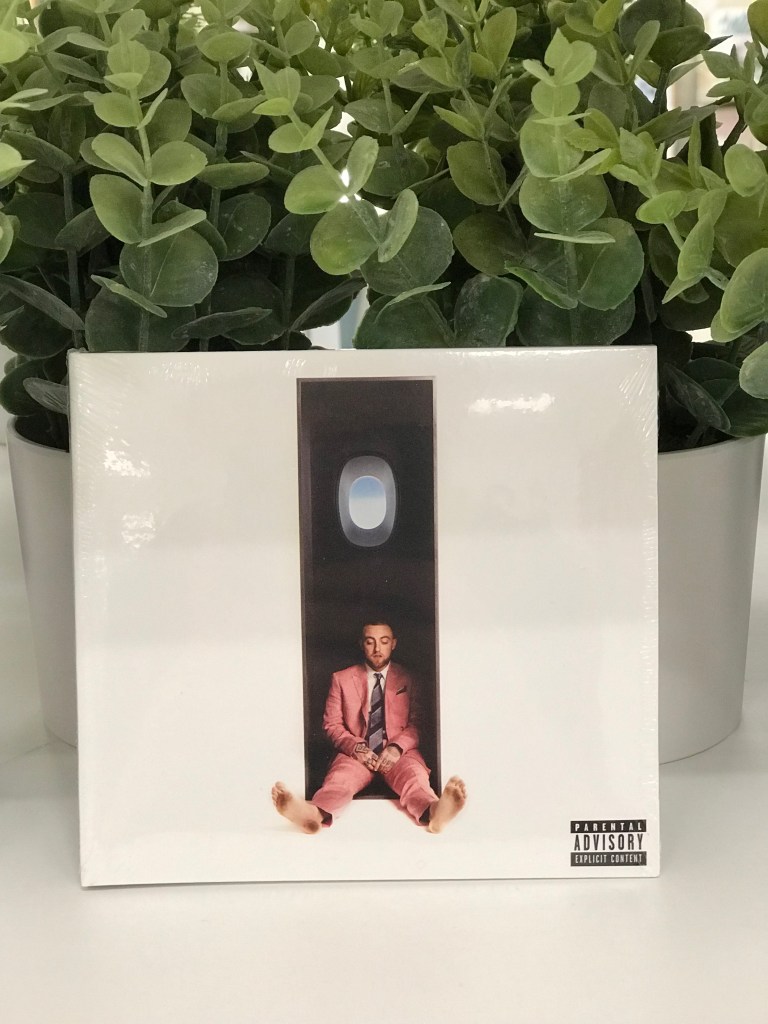 Mac Miller - "Swimming" CD laid in front of potted plants.