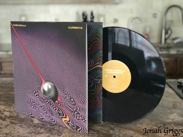 A photo of Tame Impala's "Currents" displayed on a countertop.